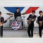 Večer z legendarno glasbo: Help! A Beatles Tribute prihaja v Kavarno Hiša